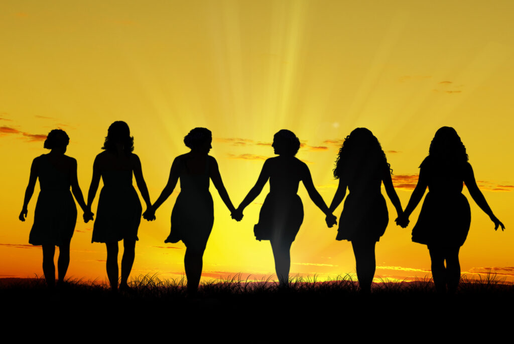 Silhouette of six young women, walking hand in hand